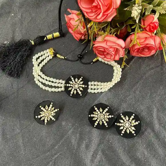 Handcrafted black fabric choker set from Itsy Bitsy Kolkata, featuring a triple-strand pearl necklace, starburst mirror-work pendant, matching earrings, and an adjustable ring.
