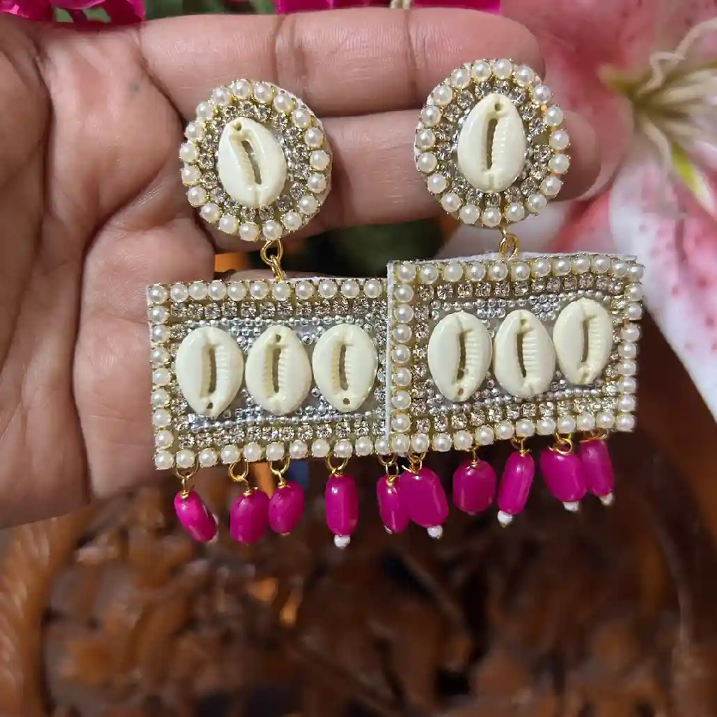 Handcrafted rectangular cowrie shell earrings with white pearls and magenta bead drops from Itsy Bitsy Kolkata.