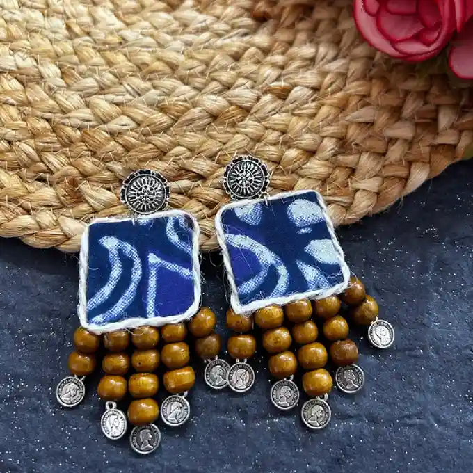 Handcrafted indigo fabric square earrings with brown wooden beads and small oxidised silver coin charms.