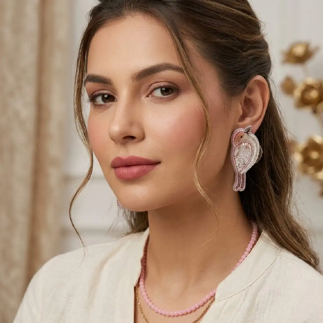 Model wearing handcrafted blush pink and silver sequin bird earrings with a pastel pink ethnic outfit – Itsy Bitsy Kolkata