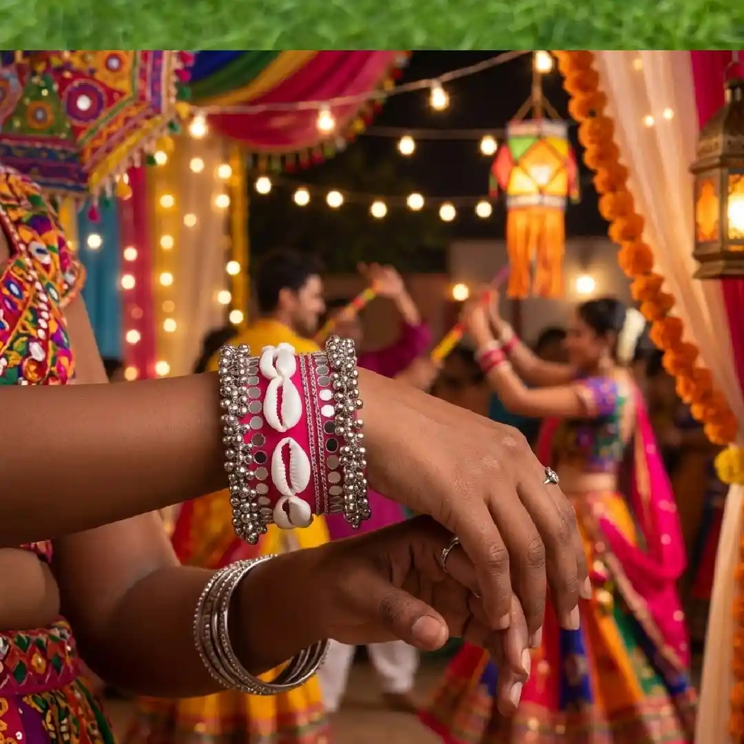 A model wearing a vibrant pink fabric handcuff with cowrie shells and mirror work, set against a festive Navratri background with colorful decorations and warm ambient lighting. 