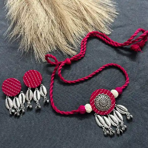 Elevate your ethnic style with our handcrafted rani pink fabric jewelry set. Featuring oxidised silver mandala art, metallic cowrie shells, and musical ghungroos. Shop at itsybitsykolkata.com.