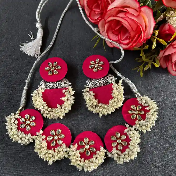 Elevate your ethnic look with our handcrafted rani pink fabric jewelry set. Featuring traditional kundan floral motifs and lush pearl clusters. Shop now at Itsy Bitsy Kolkata.