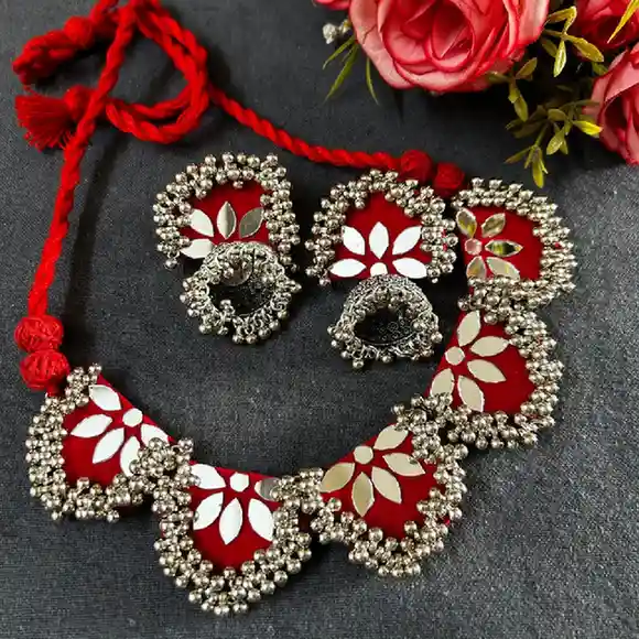 Handcrafted red fabric choker necklace and jhumka earrings set from Itsy Bitsy Kolkata featuring white floral mirror work patterns and intricate silver bead borders.